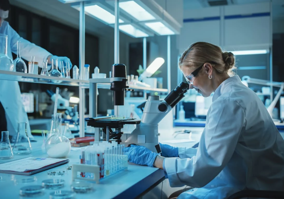 scientist_looking_through_microscope_in_lab